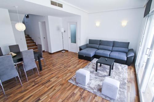 a living room with a couch and a table at NATURE PLUS Family House in Salou
