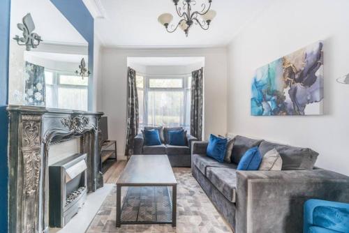a living room with a couch and a fireplace at Cosy home near Port of Hull in Hull