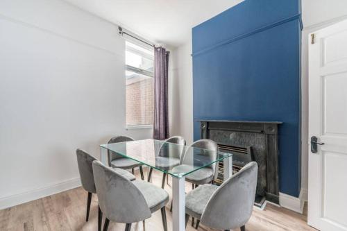 a dining room with a glass table and chairs at Cosy home near Port of Hull in Hull
