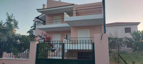 a building with a balcony and a fence at Harmony 5 in Áyios Spirídhon