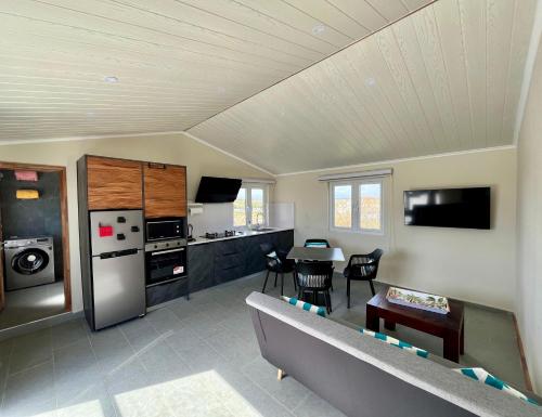 a kitchen and living room with a couch and a table at Rooftop d'exception - calme et confort à Grand Baie in Grand Baie