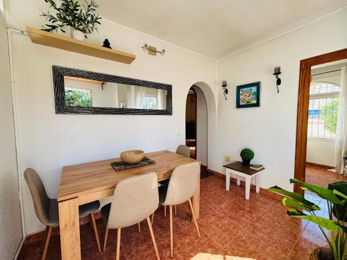 a dining room with a wooden table and chairs at Casa Zeus by SunshineClub in Los Alcázares