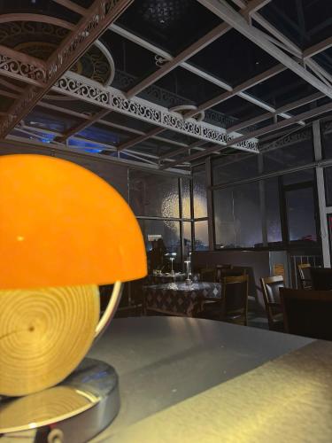 a table with a orange lamp on top of it at Hanoi Sail Hotel in Hanoi