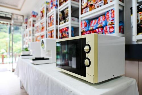 a row of microwaves on a table in a store at Gangchon Provence Pension in Kugong-ni