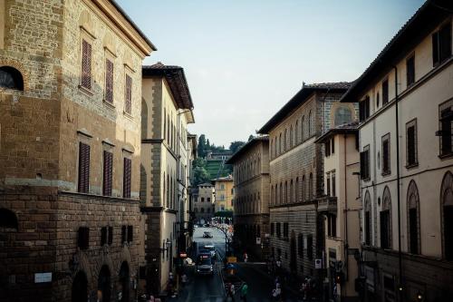 a city street with buildings and people walking down the street at Benci House in Florence