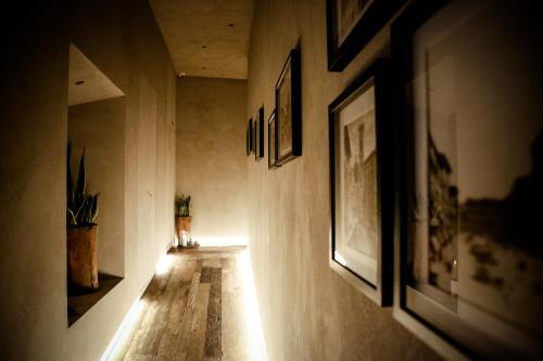 a hallway with pictures on the walls and a light on the floor at Benci House in Florence