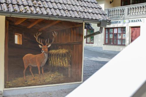 a painting of a deer on the side of a building at Resort U Jelena in Křivoklát