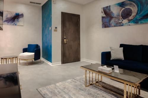 a living room with a blue couch and a table at Palazzo hotel in Kuwait