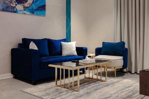 a living room with a blue couch and a table at Palazzo hotel in Kuwait