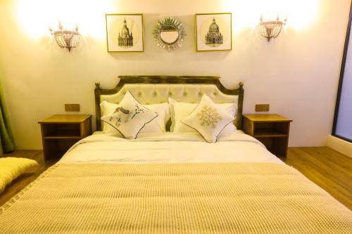 a bedroom with a large bed with two night stands at XI SHANG YUN JIAN Inn in Hanqiyu