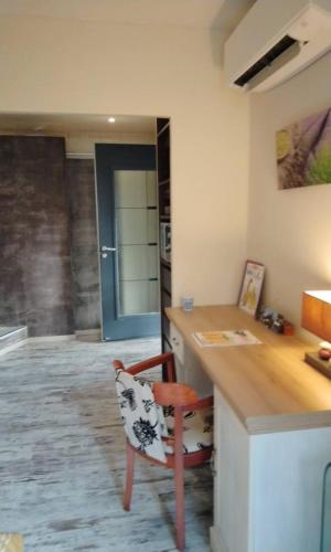 a kitchen with a counter with a chair and a desk at Chambres d'Hôtes Villa Aquitaine in Bretagne-de-Marsan
