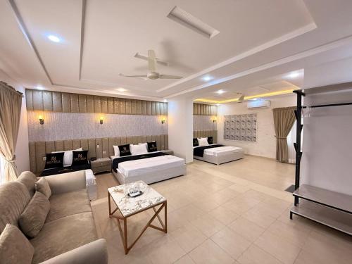 a large living room with couches and a couch at Nestopia Islamabad in Islamabad