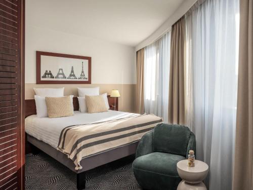 Ένα ή περισσότερα κρεβάτια σε δωμάτιο στο Mercure Paris Gare Montparnasse TGV