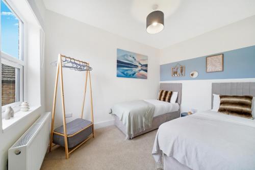 a bedroom with two beds and a swing at Charming 3BR Home in Bedford, Sleeps 5 in Bedford