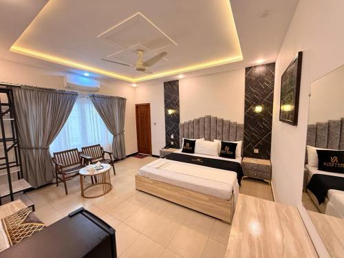 a bedroom with a bed and a living room at Nestopia Islamabad in Islamabad