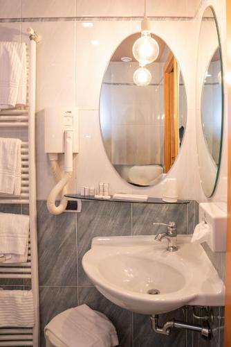 a bathroom with a sink and a mirror at SIRIOHotel in Dormelletto