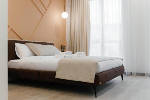 a bedroom with a large bed with white pillows at Select Hotel in Lviv