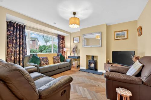 a living room with a couch and a fire place at Central Belfast Apartments Rosetta Residence in Belfast