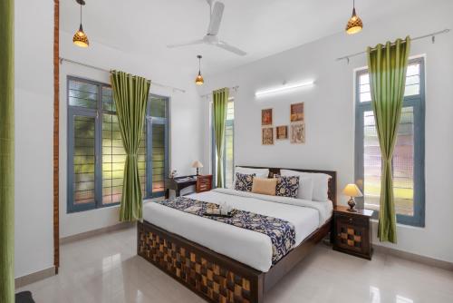 a bedroom with a bed and some windows at The Castle Villa - Luxury Villa Resort with Private Swimming Pool in Udaipur