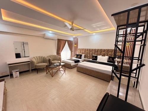 a large living room with a bed and a couch at Nestopia Islamabad in Islamabad