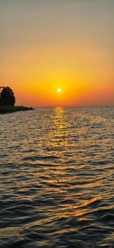 a sunset over a body of water with the ocean at Molet apartments Koper in Koper