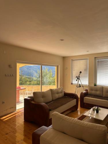 a living room with a couch and a table at Villa Kalin Kamen in Kriva Palanka