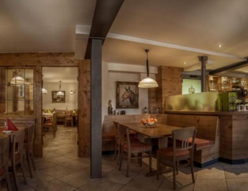 a kitchen and dining room with a table and chairs at Gasthaus Krone in Weingarten