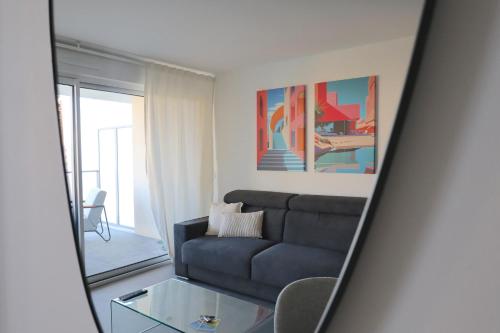 a living room with a couch and a glass table at Sun Paradise SeaView&Terrace Parking&Pool in Beausoleil