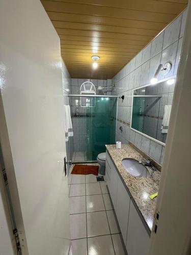un bagno con doccia, lavandino e WC di Apartamento em prédio na Praia do Morro a Guarapari