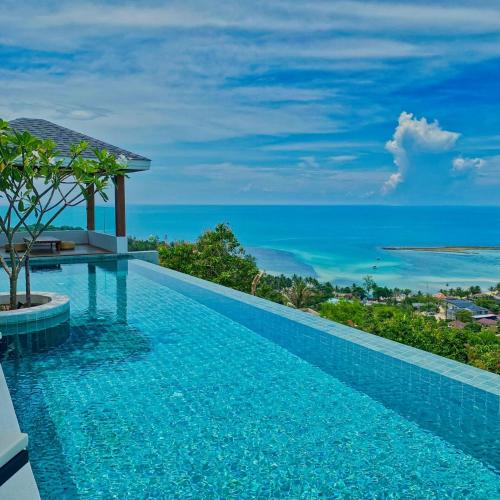 a swimming pool with a view of the ocean at Anzhu Seamate Villa Samui in Amphoe Koh Samui