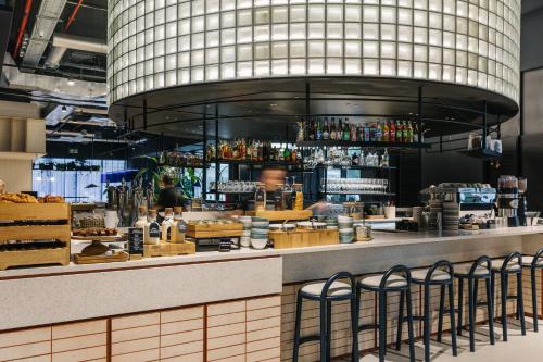 a restaurant with a bar with stools at The Social Hub San Sebastián in Donostia-San Sebastián