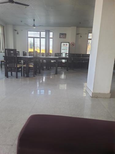 a dining room with tables and chairs and windows at Rest area 