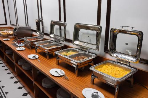 a buffet with several trays of food on a table at Tam Coc Orchid Hotel & Spa in Ninh Binh