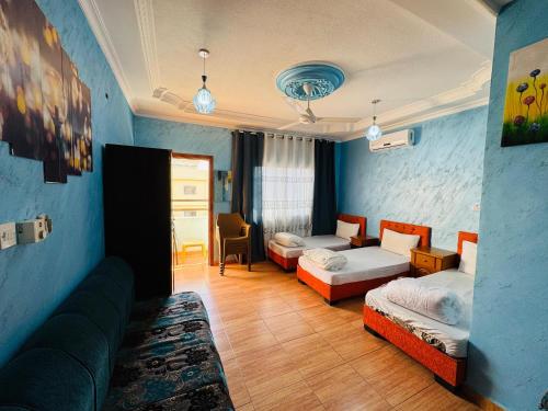a living room with two beds and a couch at Serdyanax Apt in Aqaba