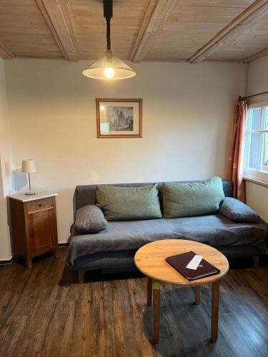 a living room with a couch and a table at Gästehaus Gerlinger in Rothenburg ob der Tauber