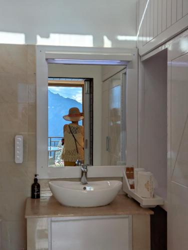 a person taking a picture in a bathroom mirror at Hunza Hard Rock Resort in Baltit