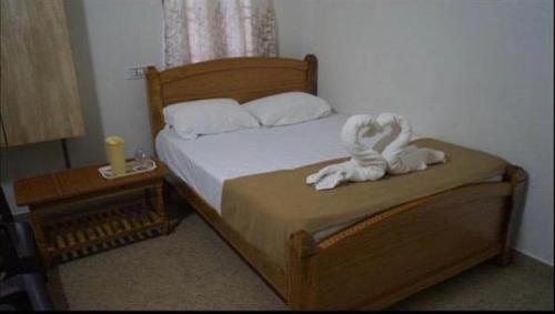a bedroom with a bed with white towels on it at Prajay Inn in Yelagiri