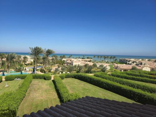 a view of a garden with the ocean in the background at La vista 5 ain sokhna Luxury sea view عين سخنة لا فيستا in Ain Sokhna