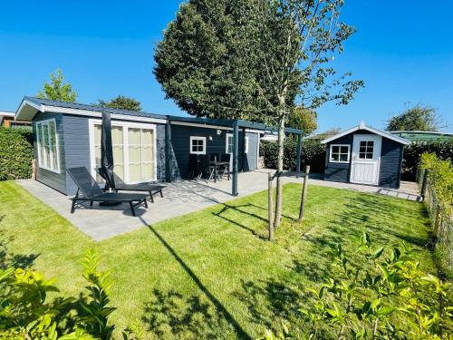 a tiny house in a yard with a patio at Chalet VeerLake in Lathum