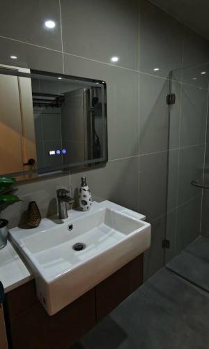 a bathroom with a white sink and a shower at Palm Spring 301 in Patong Beach