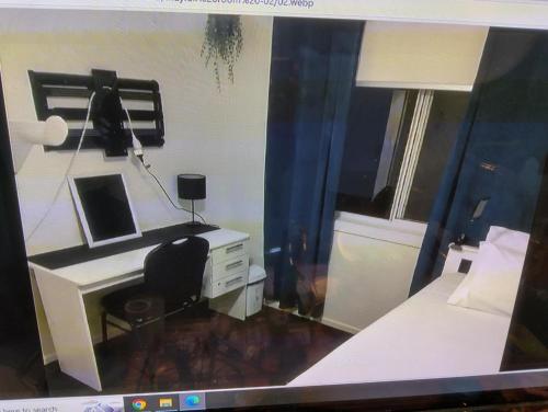 an office with a desk and a computer in a room at Room for rent in Kallangur