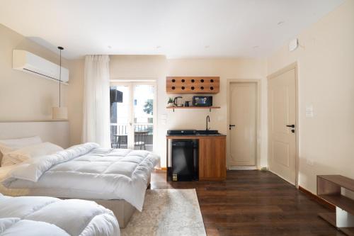 a room with three beds and a kitchen with a window at The Twin Bliss in Cairo
