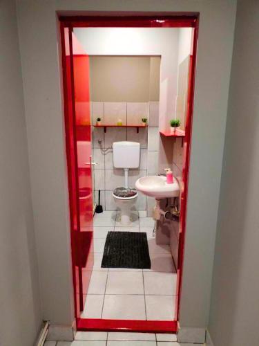 a small bathroom with a toilet and a sink at Skitnica Red door in Koprivnica