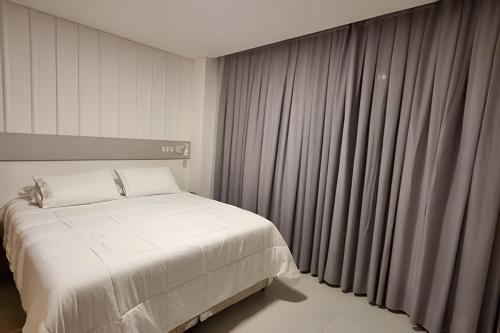 Postel nebo postele na pokoji v ubytování Loft Feldmann localização estratégica