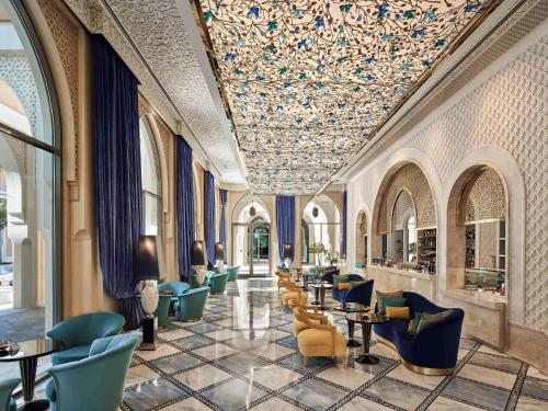 a lobby with chairs and tables and a ceiling covered in flowers at Club Privé By Rixos Saadiyat in Abu Dhabi