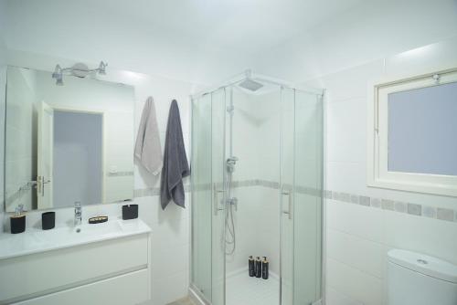 a white bathroom with a shower and a sink at Casa Calma III in Tacoronte