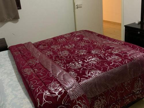 a bed with a red bedspread with roses on it at One Bedroom Chalet with Side Sea View ,Turtles, Hurghada Concierge D 14 6 in Hurghada