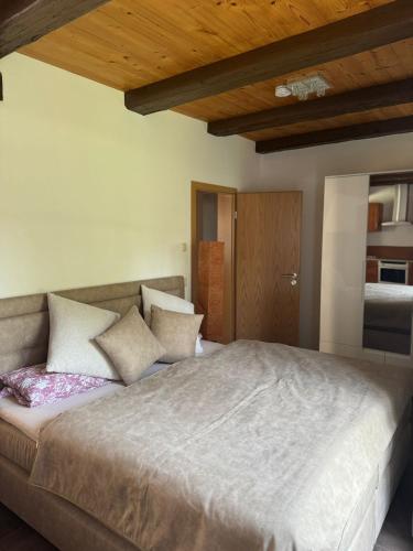 a bedroom with a large bed with pillows at Quiet apartment in Dresden in Dresden