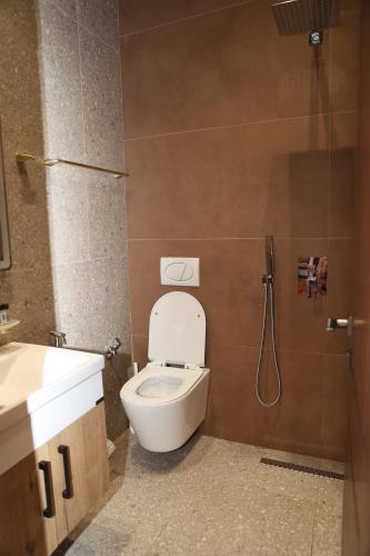 a bathroom with a toilet and a sink and a shower at Villa Starova in Berat