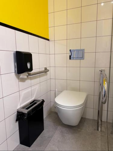 a bathroom with a toilet and a phone on the wall at Optima Collection Mural Lviv in Lviv